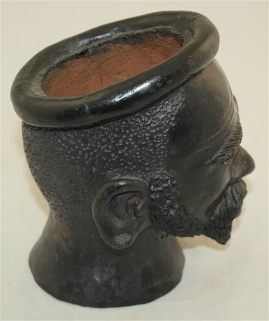 An African painted terracotta jar modelled as the head of a bearded man, 7.5in.